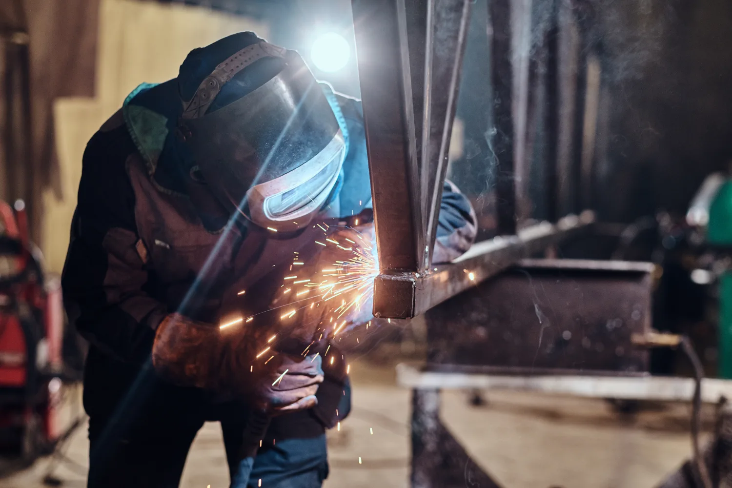 man-is-working-metal-factory-he-is-welding-piece-rail-using-special-tools man-welding-old-shovel-close-up
